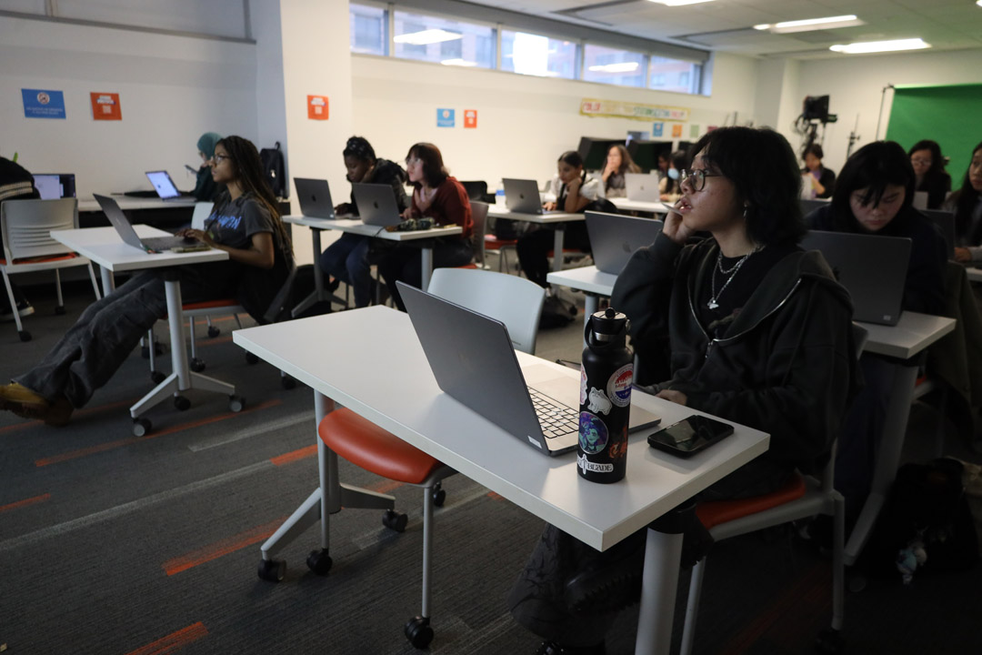 Students in the NMA Studio playing with cameras.