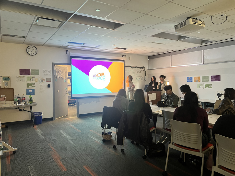 Students watching a presentation about the New Media Artspace by three members of the Docent team.