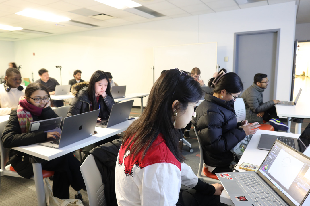 Students working on laptops in the NMA Studio.